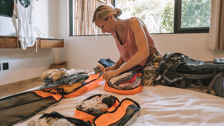 woman packing with many pink cubes