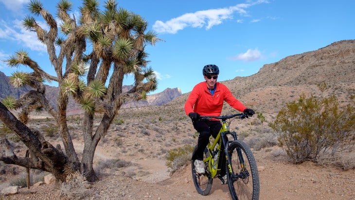 man rides his bike in the desert around Rock Rock Conservation Area, a stop on one of the best road trips in the southwest