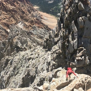 person climbing mountain rough terrain