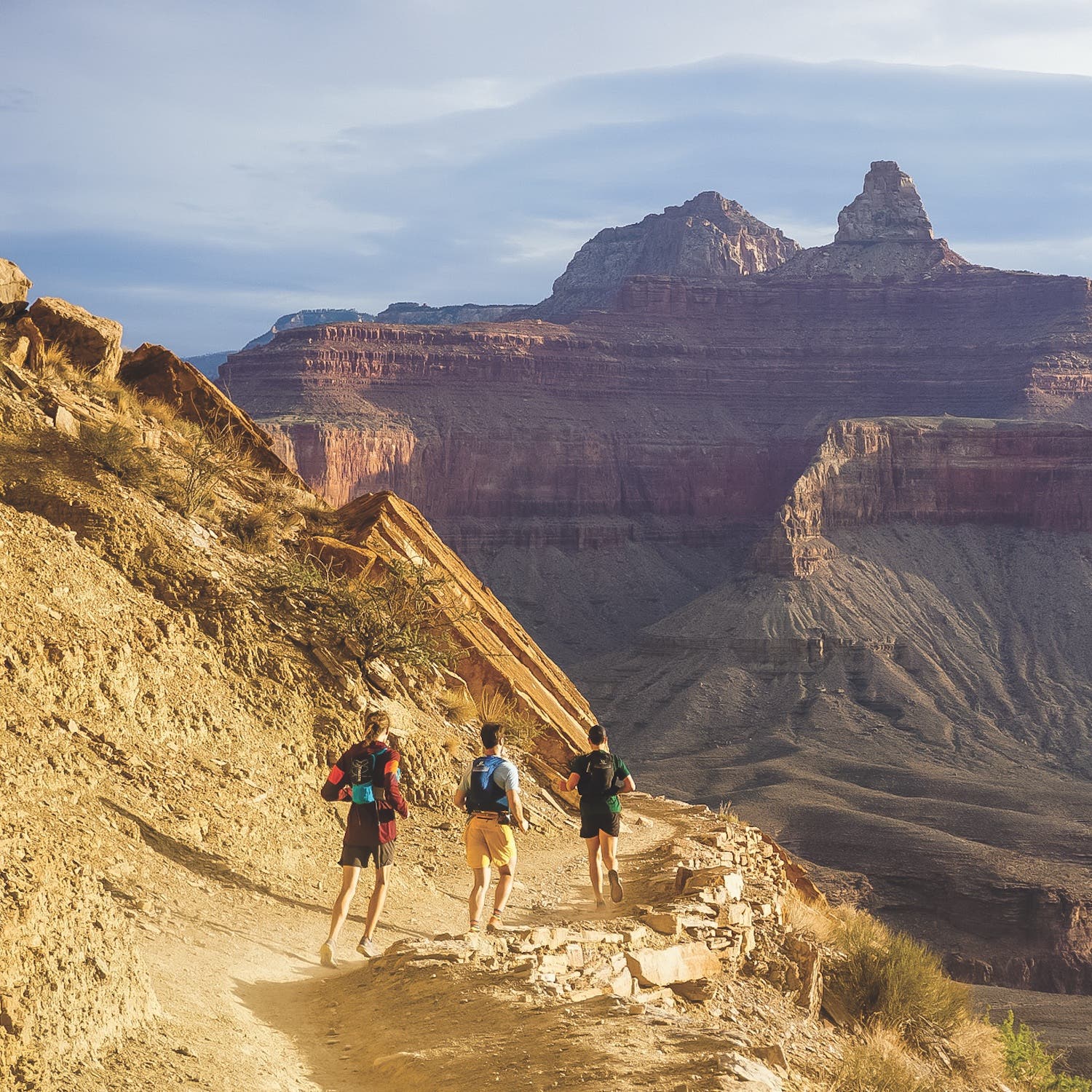 runners descending canyon trail