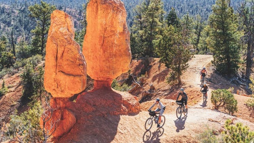 bikers riding by red rocks