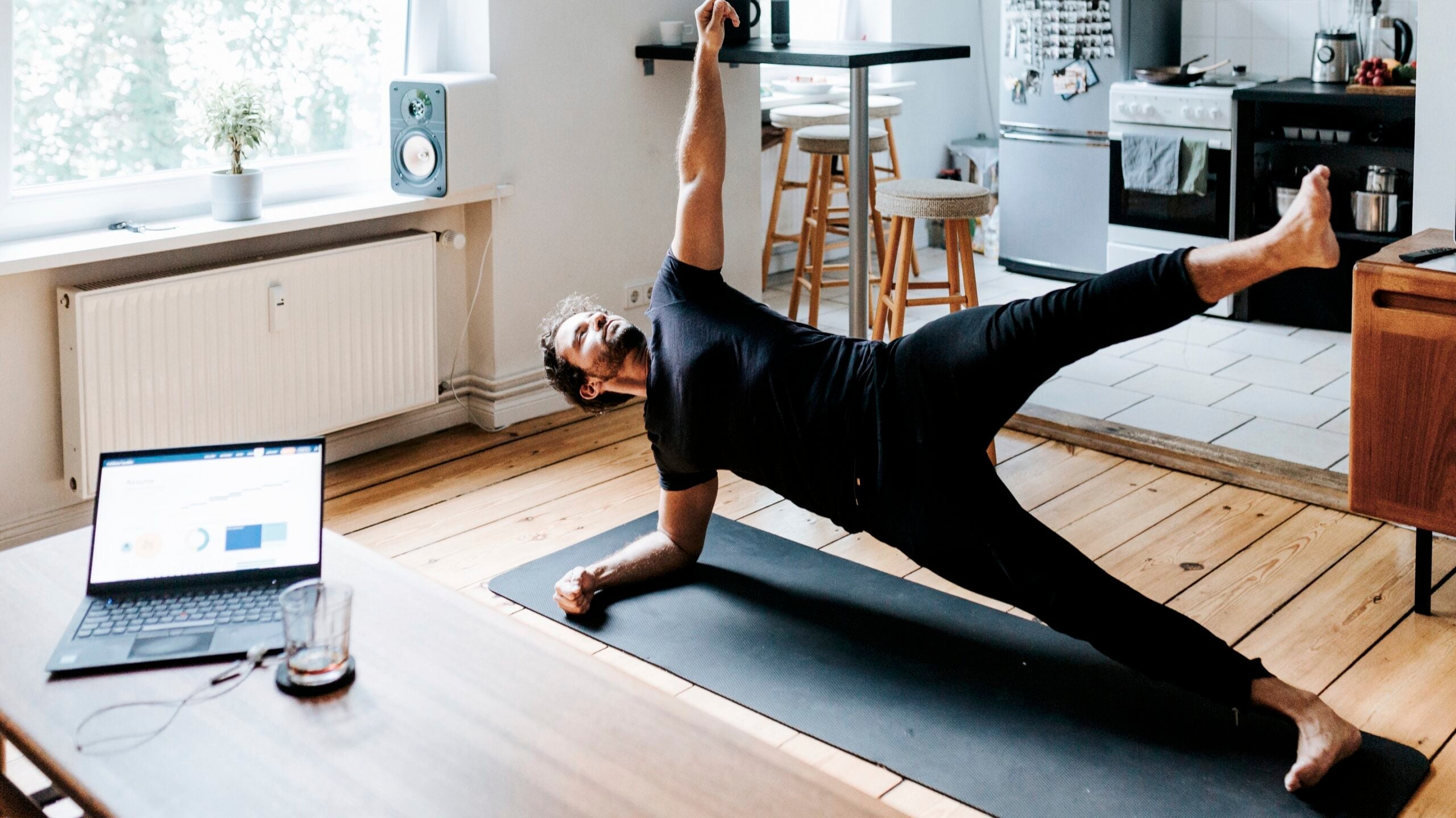 Guy on a yoga mat at home practicing core strength for yoga