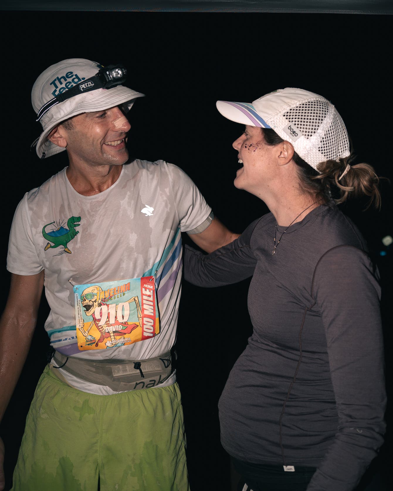 Megan Roche and David Roche smile in the dark during a race