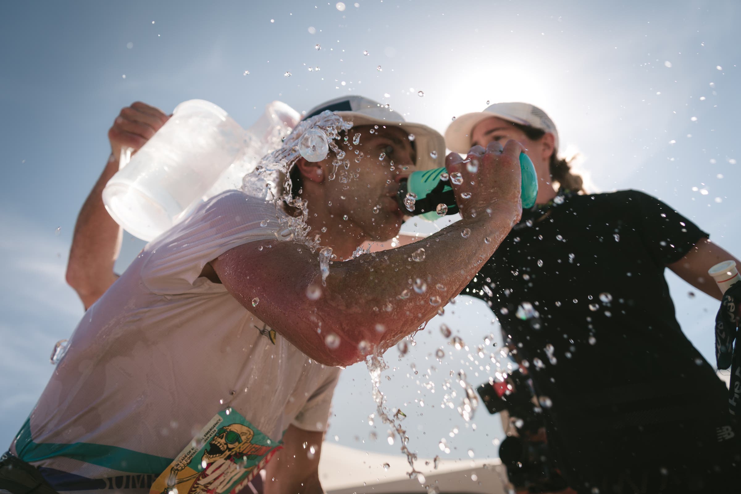 Megan Roche pours water on David Roche during a race.
