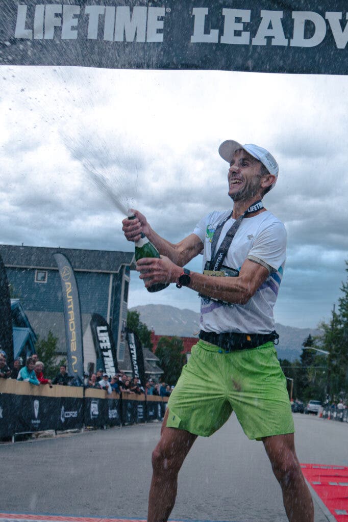 David Roche sprays champagne at the Leadville 100 Race finish line