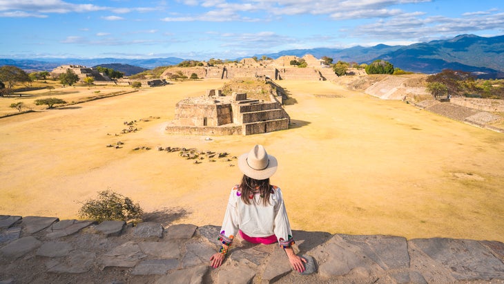 Woman admiring Monte Alban archaeological site, Oaxaca, Mexico