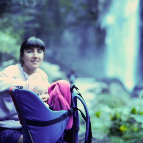 old photo of woman with her baby in backpack carrier