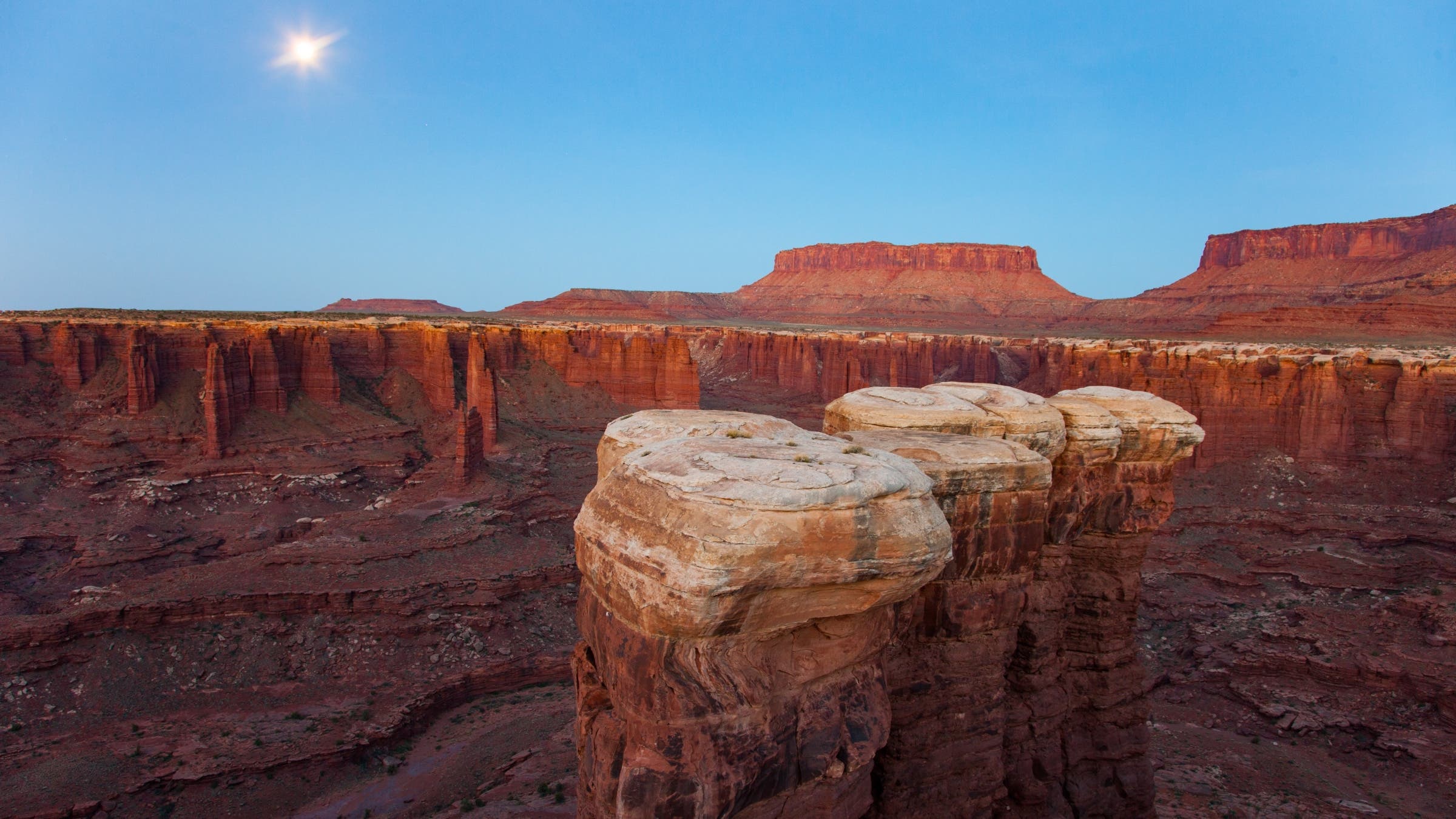 Sandstone hoodoos in Monument Basin with Junction Butte and Grandview Point behind. Canyonlands National Park, Utah.