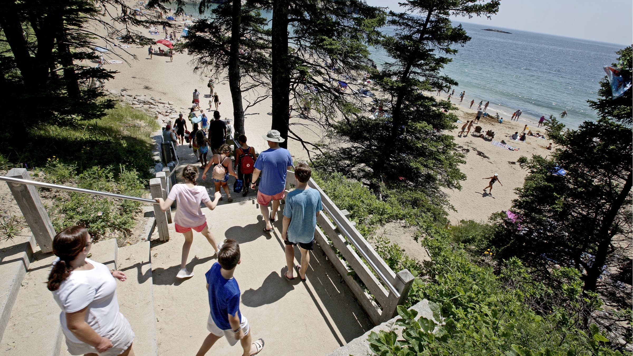Park visitors fill the stairs leading to Sand Beach, one of the most popular spots in Acadia National Park.