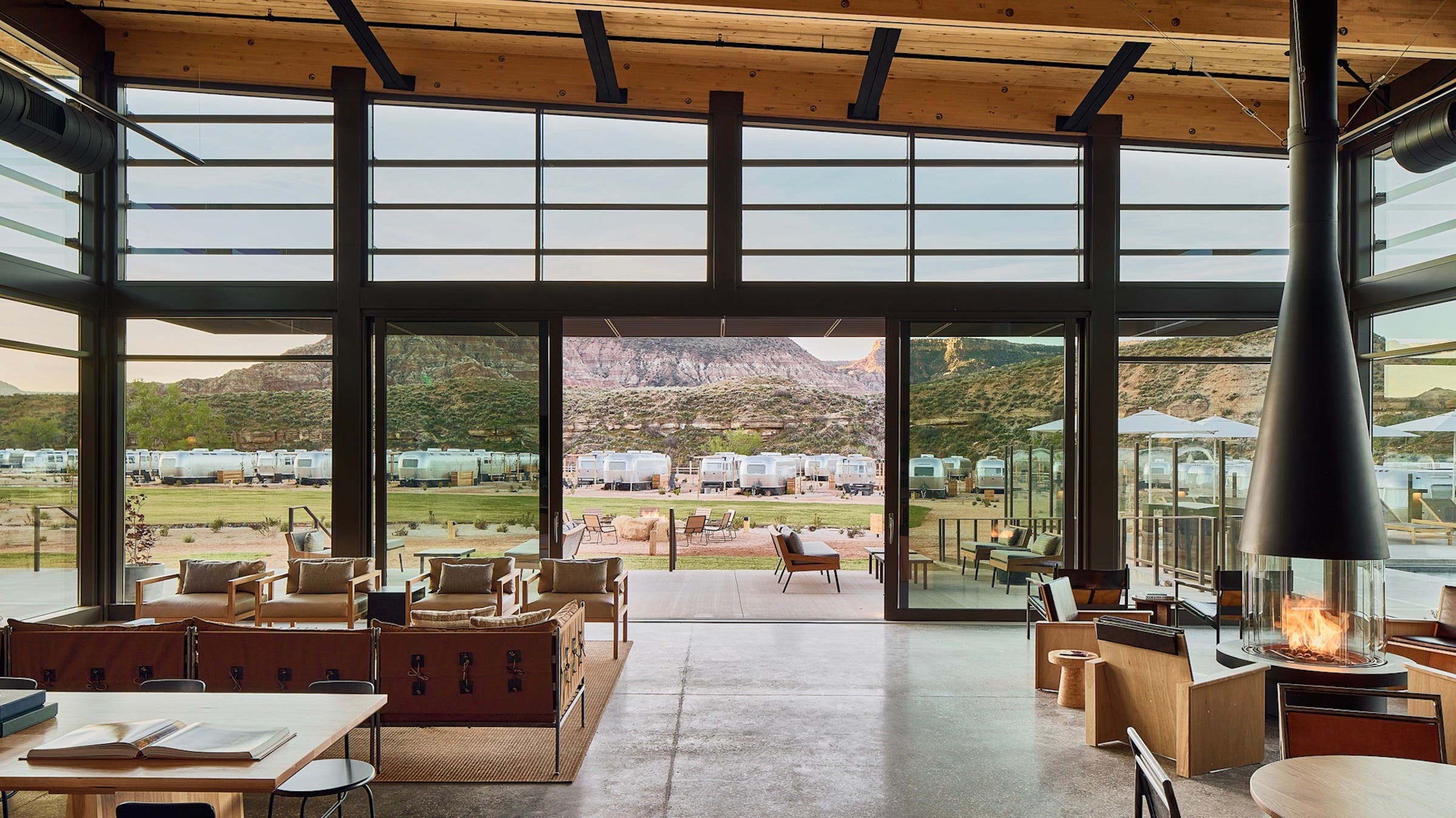 indoor-outdoor room looking out at desert mountains and Airstreams