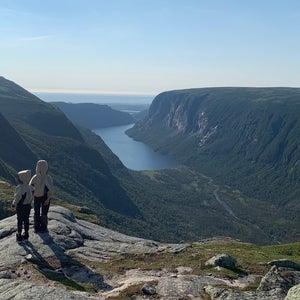 two children standing on rock overlooking huge river valley