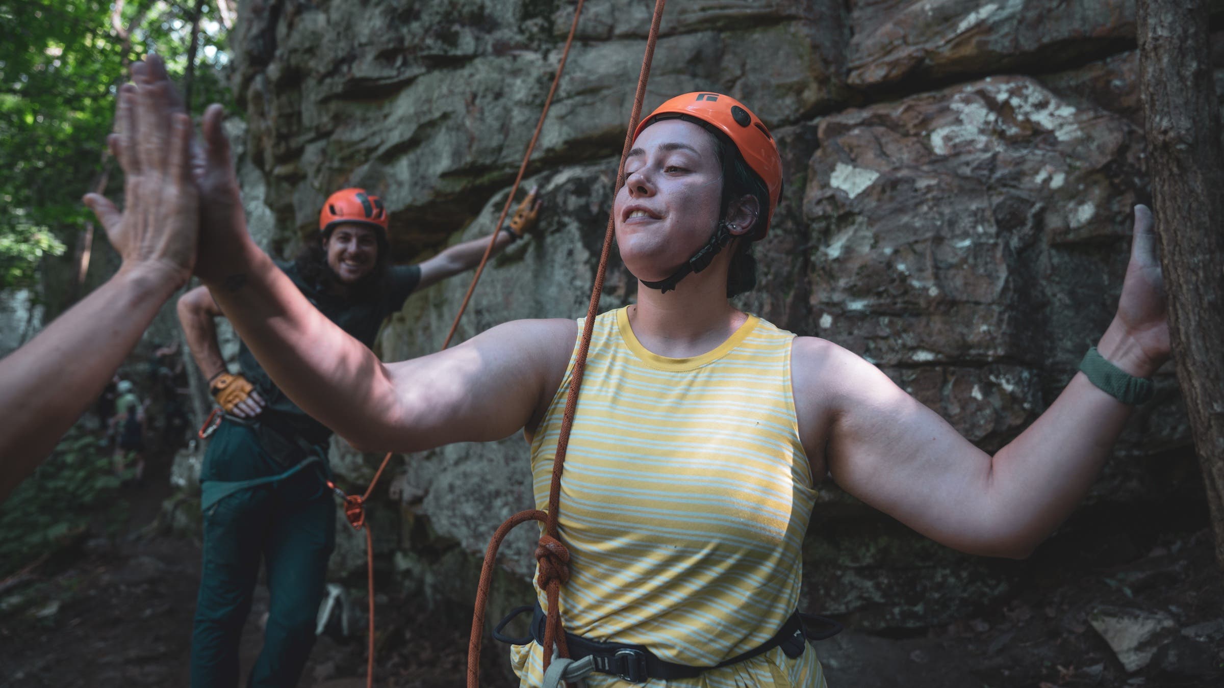 high fiving rock climber at crag