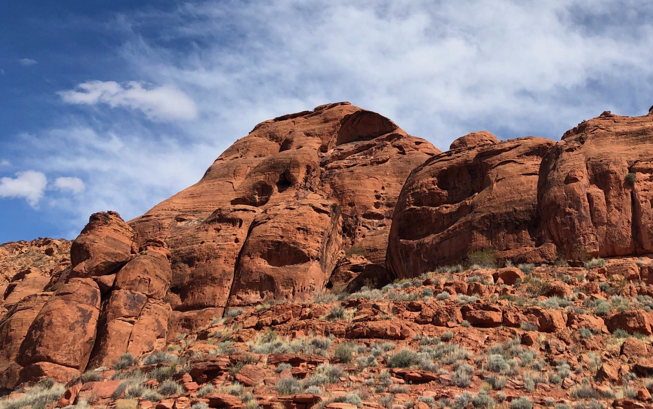 red cliffs rise up from a hill