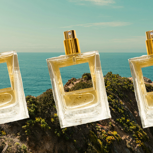 Bottles of perfumes on a landscape; showcasing travel and outdoor-inspired fragrances