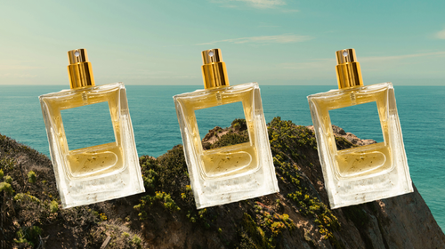 Bottles of perfumes on a landscape; showcasing travel and outdoor-inspired fragrances