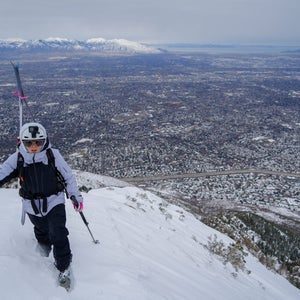 Mali Noyes stands atop Medusa's Face with Salt Lake City in the background