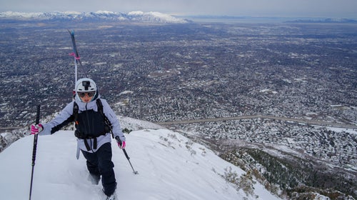 Mali Noyes stands atop Medusa's Face with Salt Lake City in the background