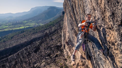 Chris Frick rebolts 'Fish Eye' in Oliana after a wildfire burnt the cliff.