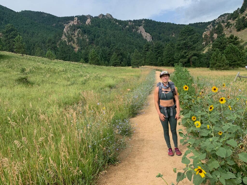female hiker wears green leggings on a trail in Colorado