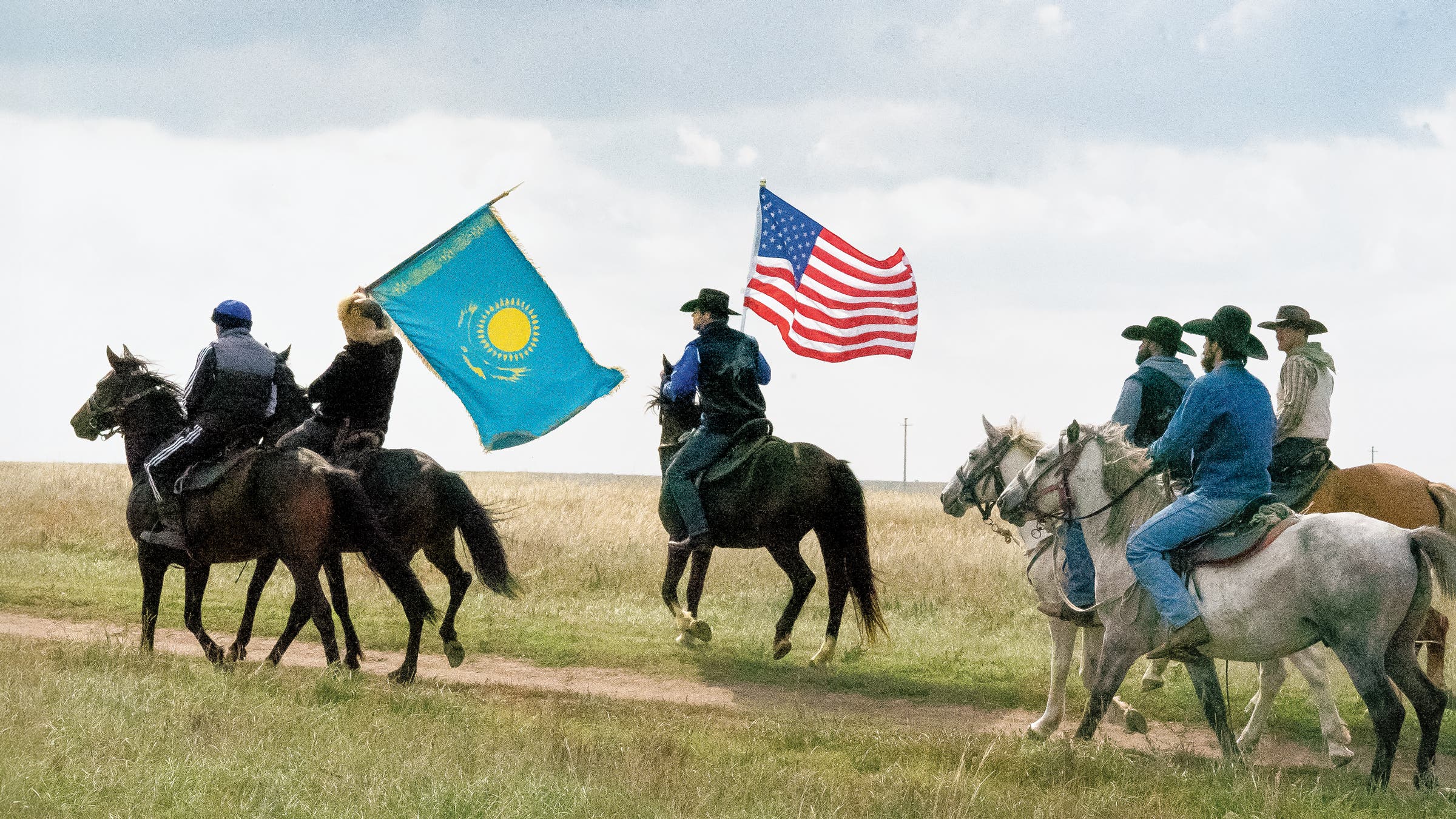 Jase Nisveta, far right, bears the U.S. flag alongside the Kazakhstan flag carrier at a yurt camp outside Astana.