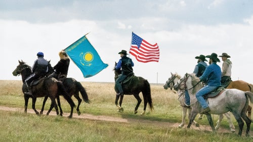 Jase Nisveta, far right, bears the U.S. flag alongside the Kazakhstan flag carrier at a yurt camp outside Astana.