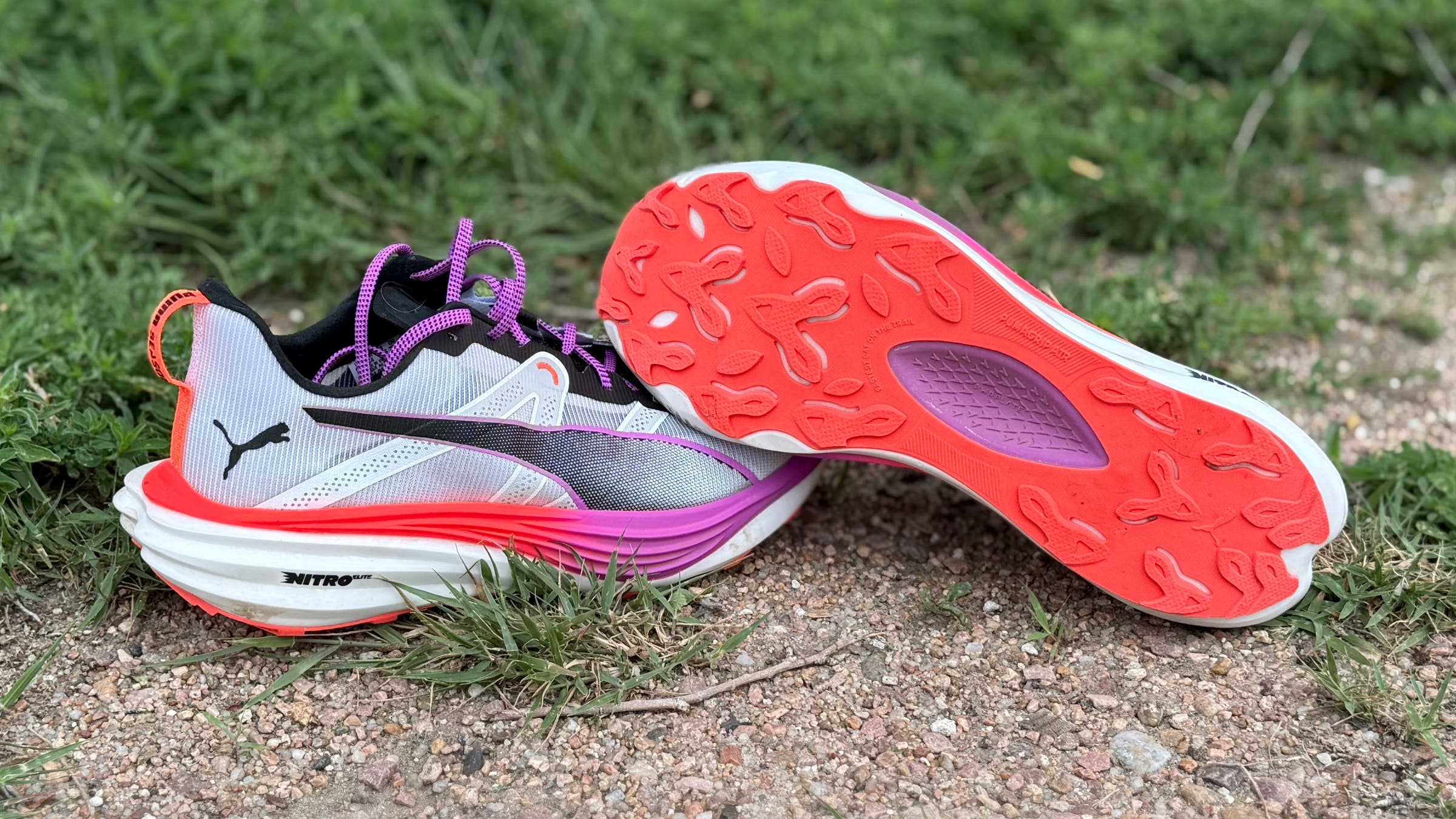 Puma Deviate Nitro Elite Trail trail running shoe, shown on the side of the trail
