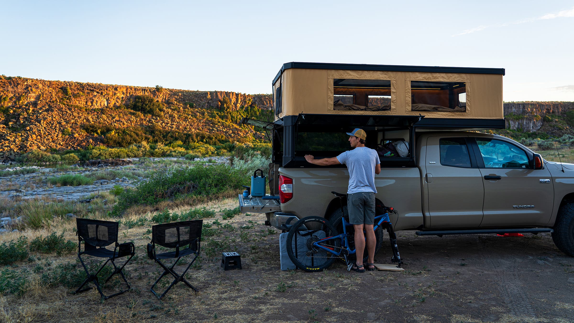 Bryan Rogala sets up camp out of the Tune M1 truck camper, parked in desert camp spot