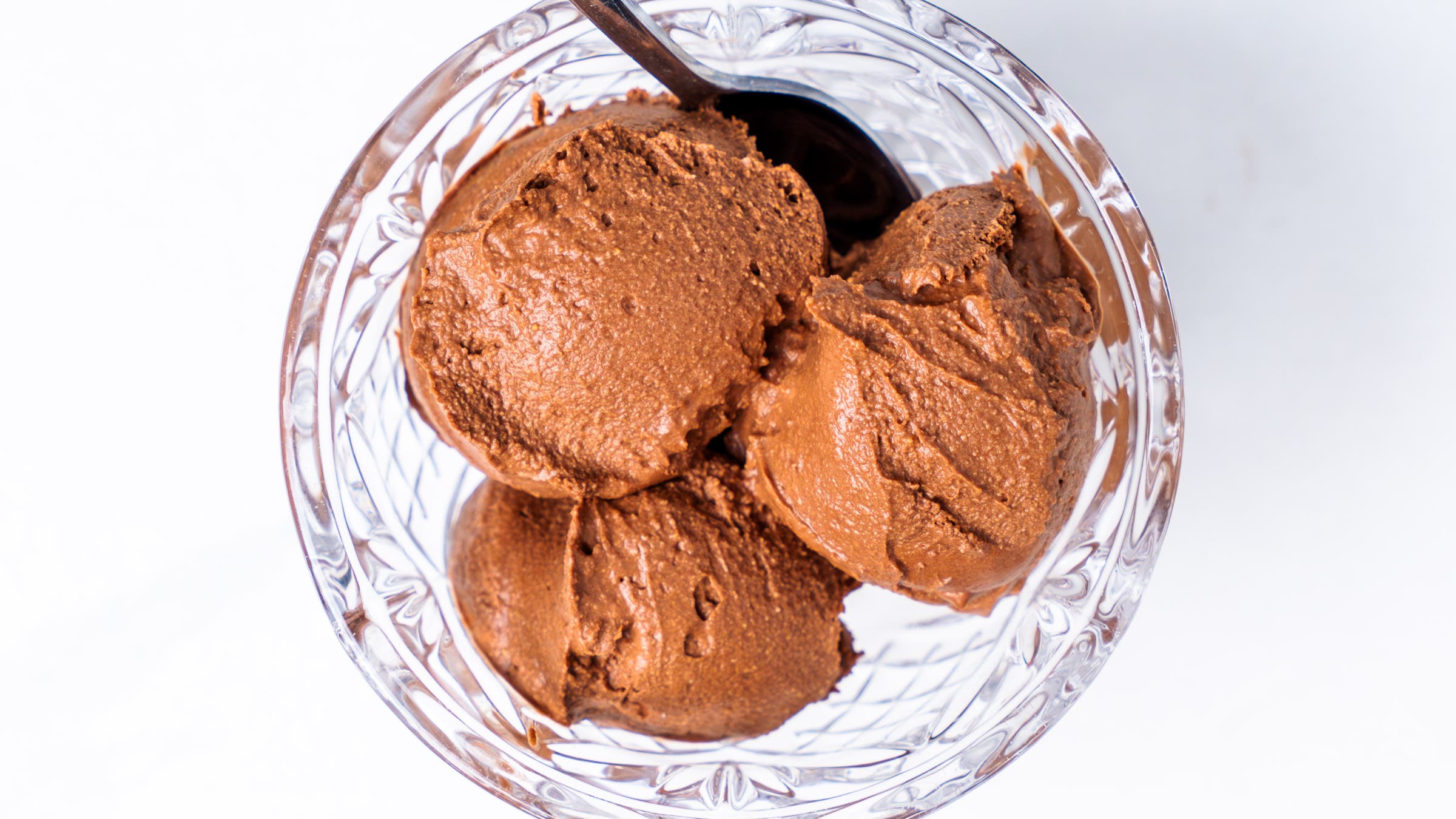 Three scoops of aloe vera gel, aloe vera juice coconut ice cream in a bowl with a spoon. aloe vera ice cream recipe