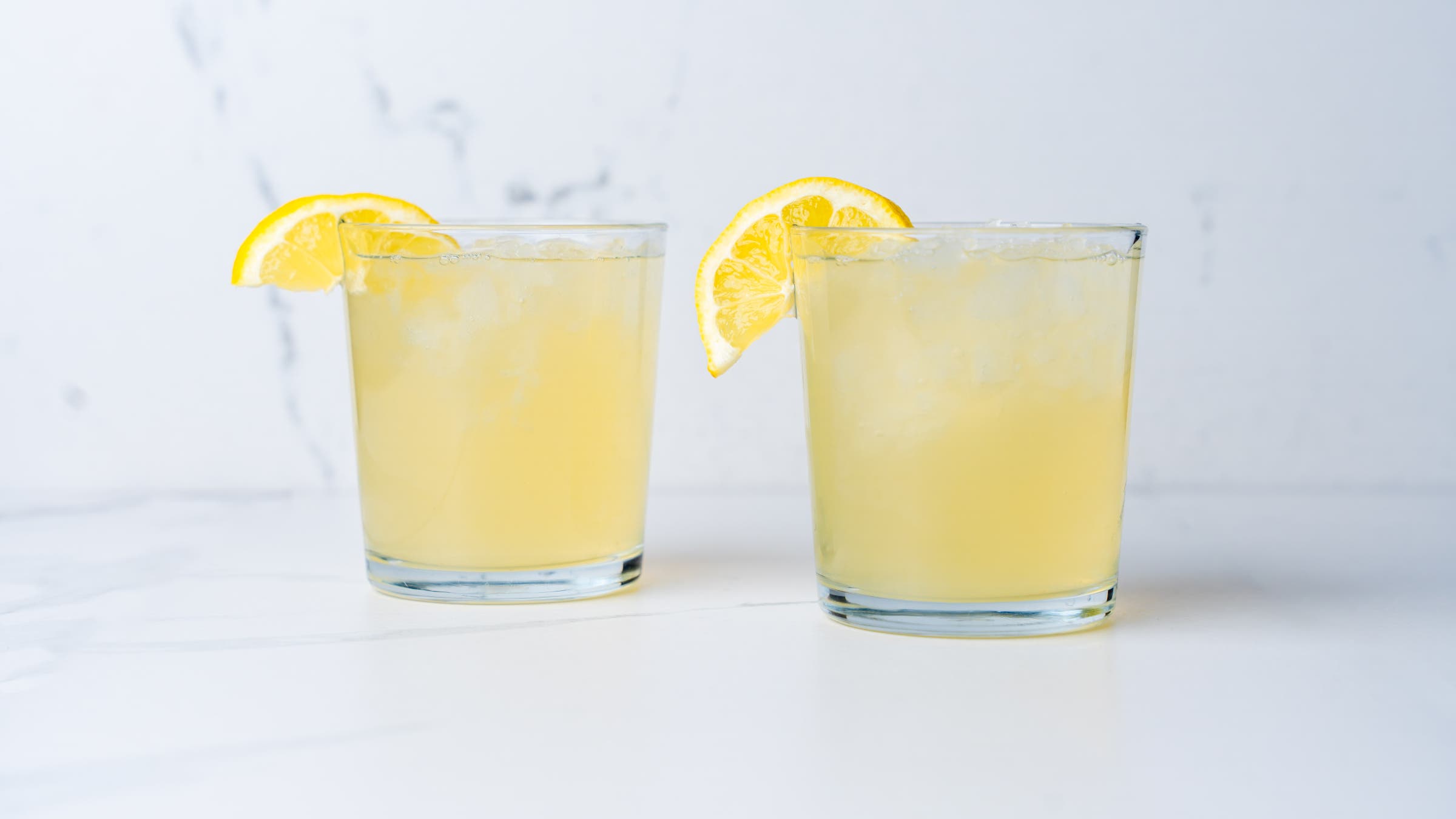 Aloe vera lemonade recipe; two glasses filled to the brim with yellow lemonade