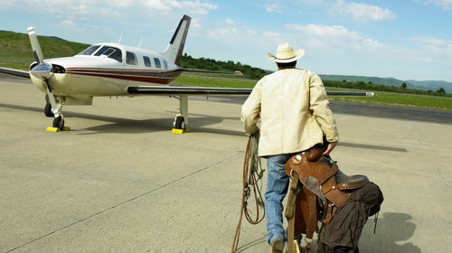 Cowboy walking to the plane