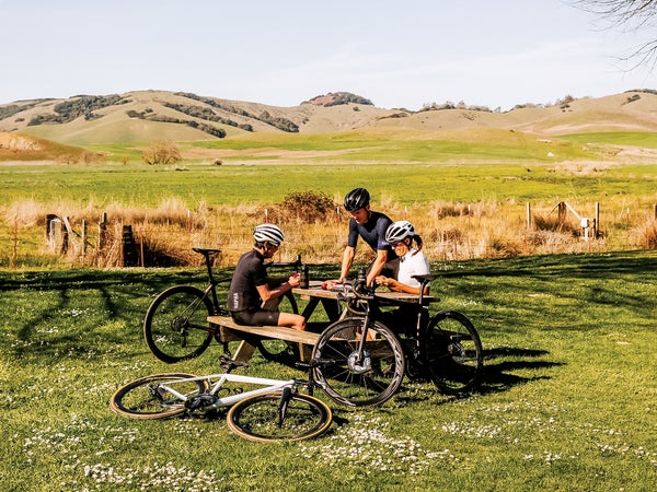 cyclists resting at a picnic table