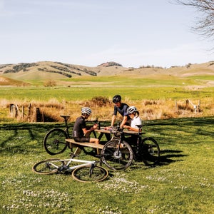 cyclists resting at a picnic table