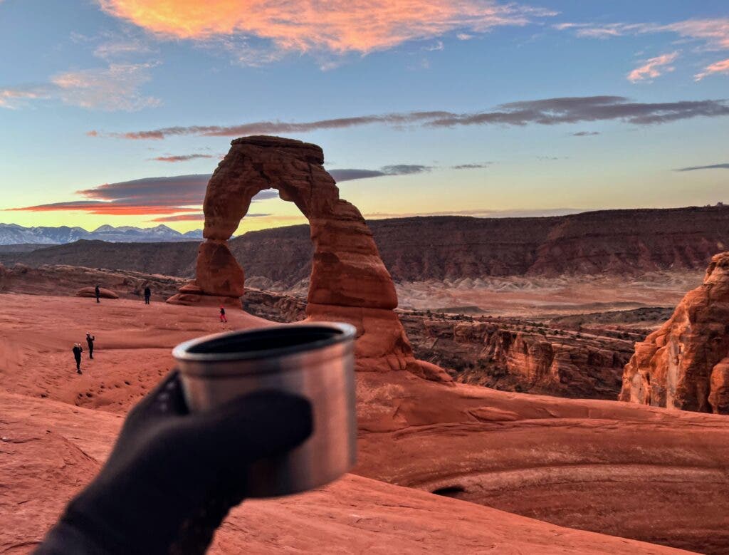A cup of coffee in front of an arch