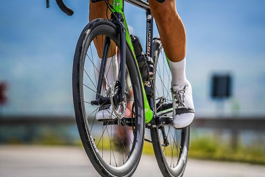 a pair of legs pedaling a bicycle