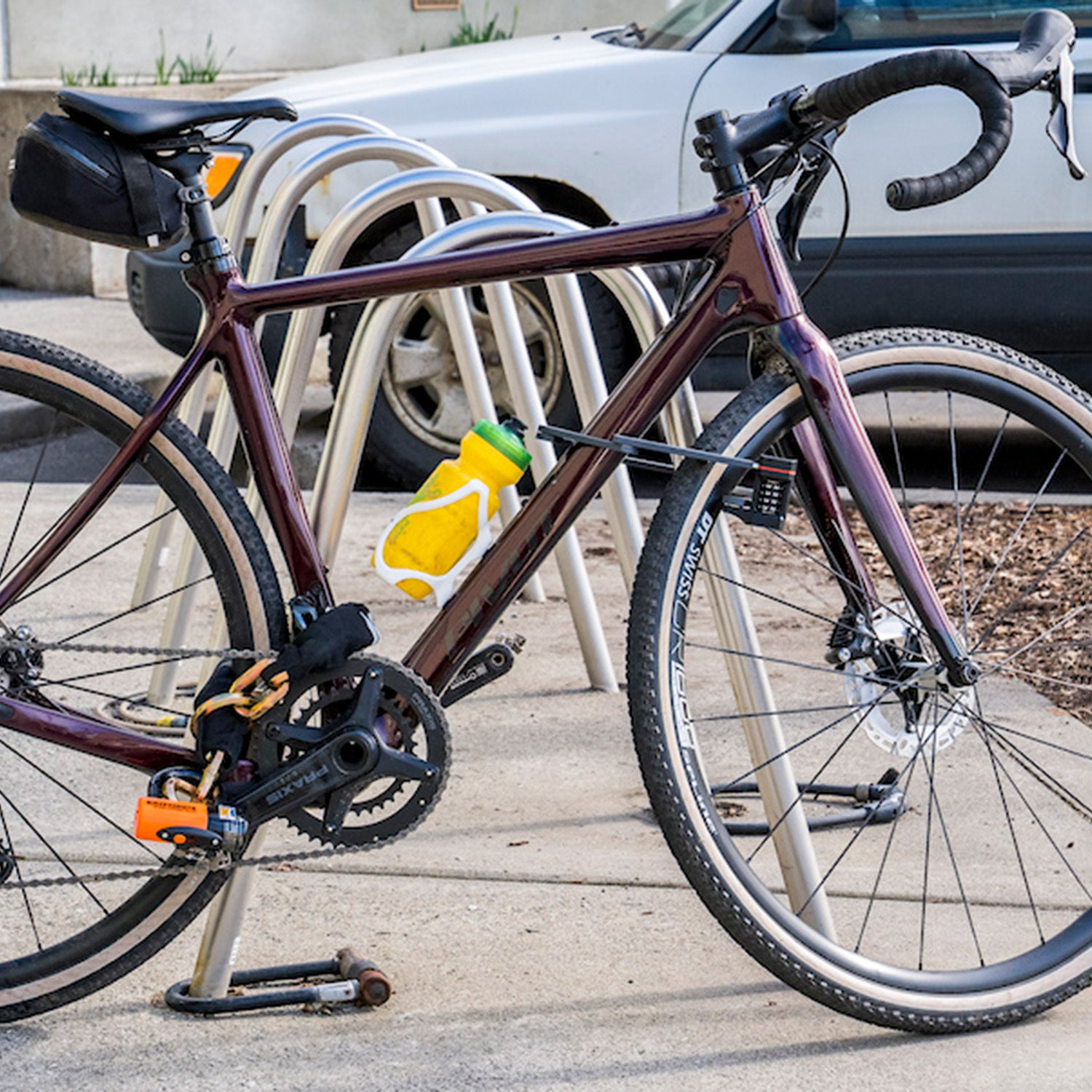 a road bike chained to a bike rack with one of the best bike locks