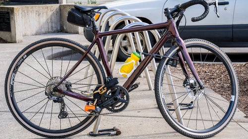 a road bike chained to a bike rack with one of the best bike locks