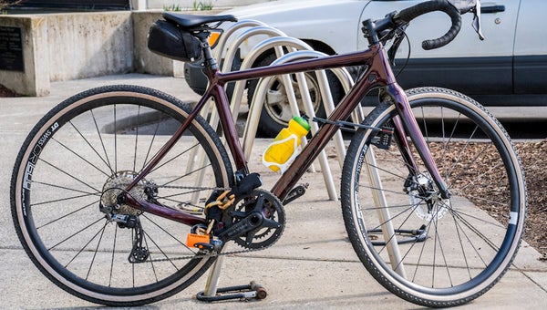 a road bike chained to a bike rack with one of the best bike locks