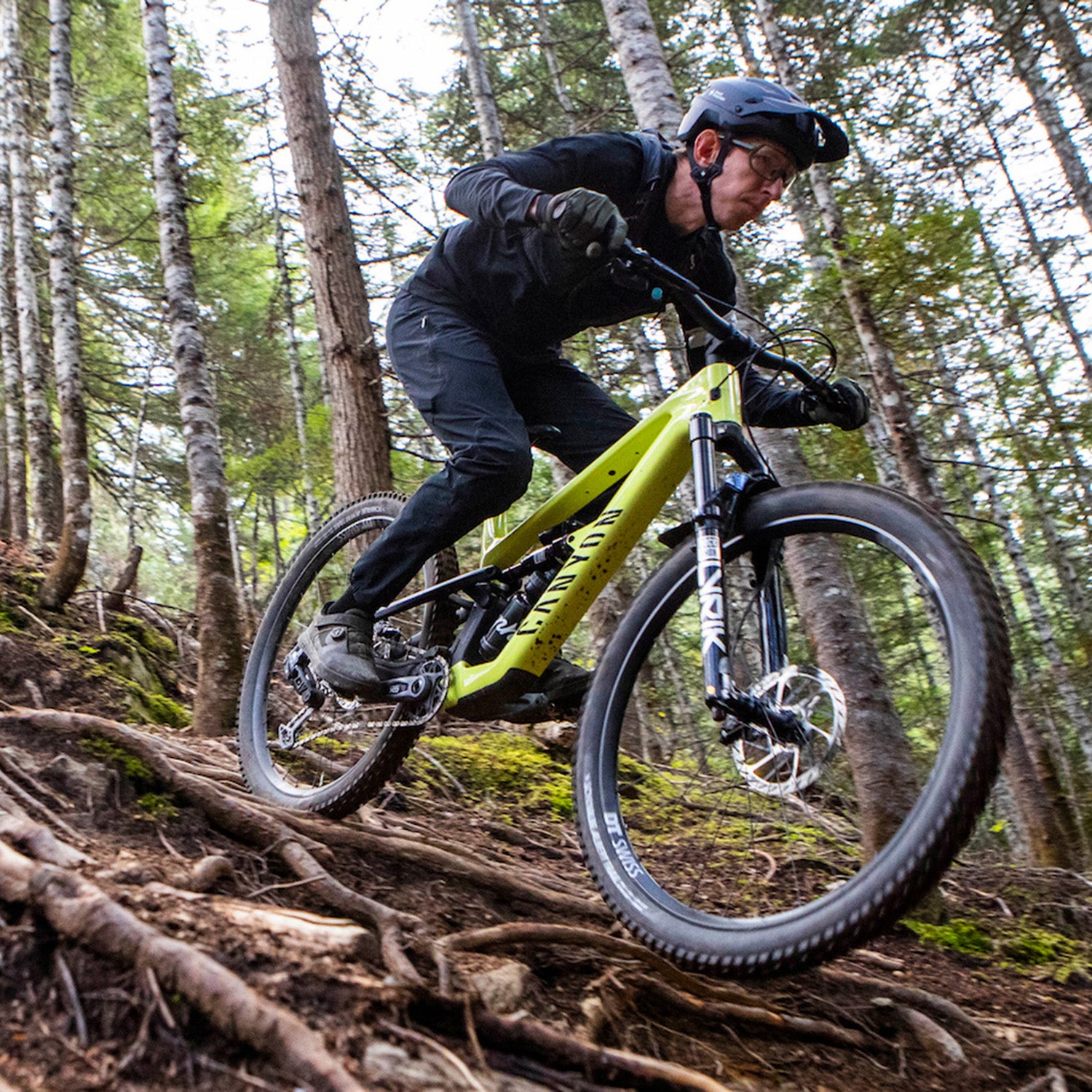 Pinkbike edior Mike Kazimer rides the Canyon Spectral trail bike over roots on downhill trail