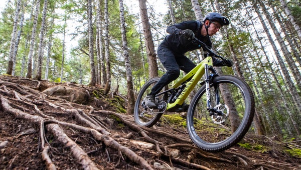 Pinkbike edior Mike Kazimer rides the Canyon Spectral trail bike over roots on downhill trail