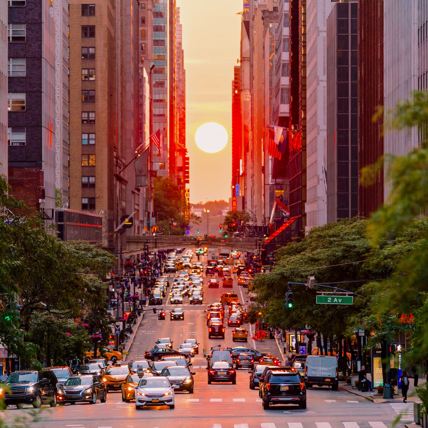 City traffic at sunset during Manhattanhenge in New York City, USA