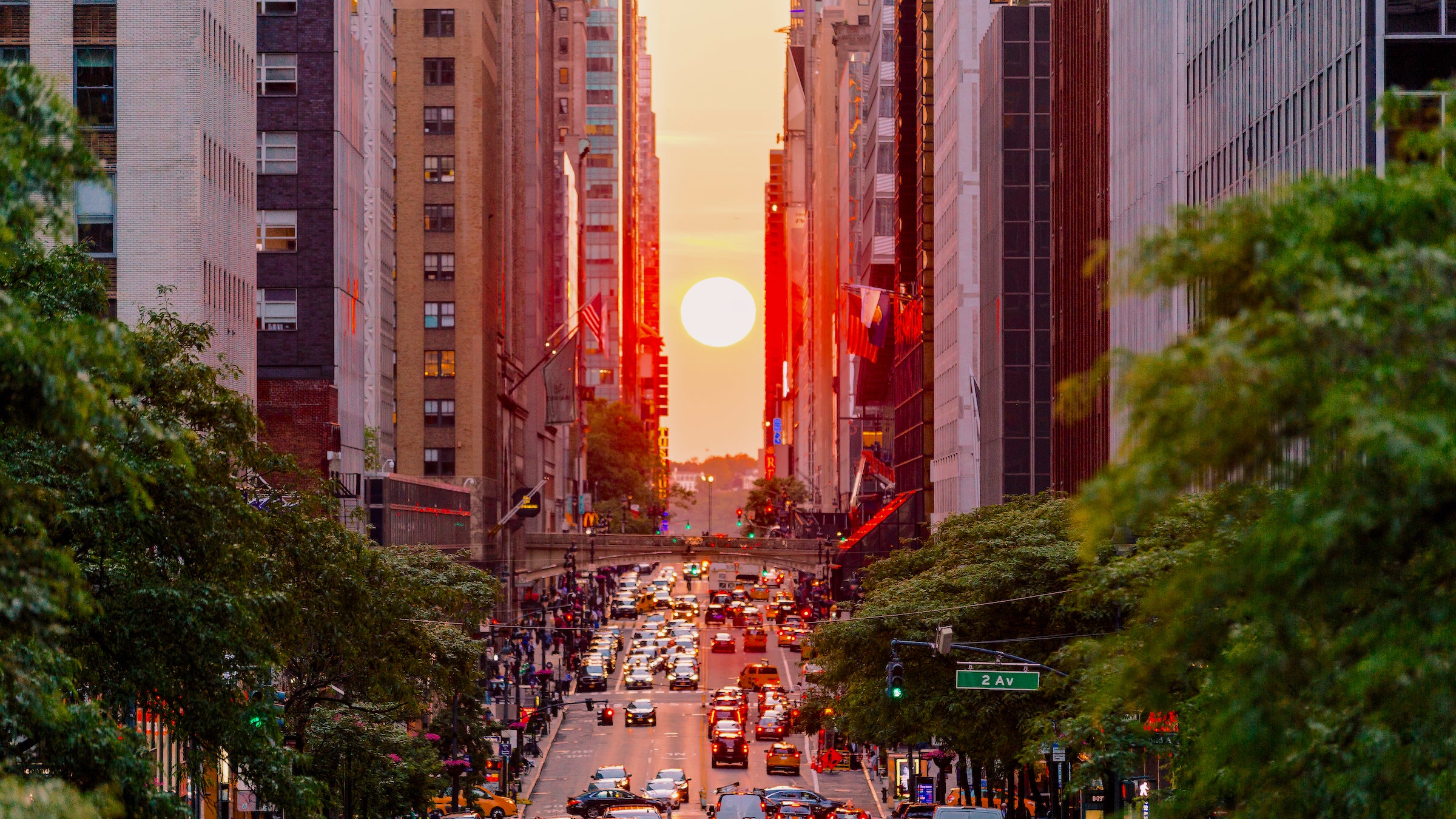 City traffic at sunset during Manhattanhenge in New York City, USA