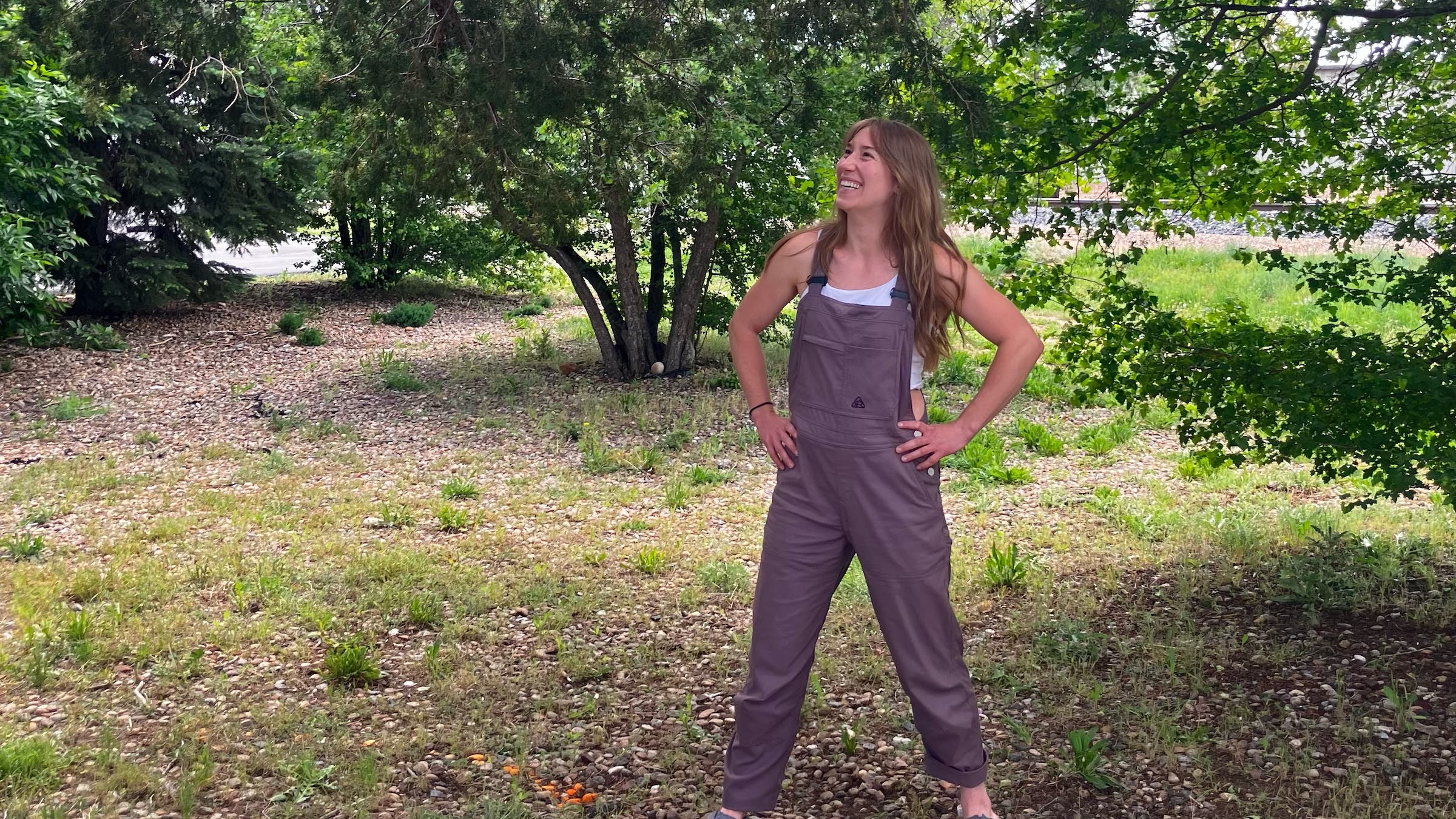 Woman wearing purple overalls outside