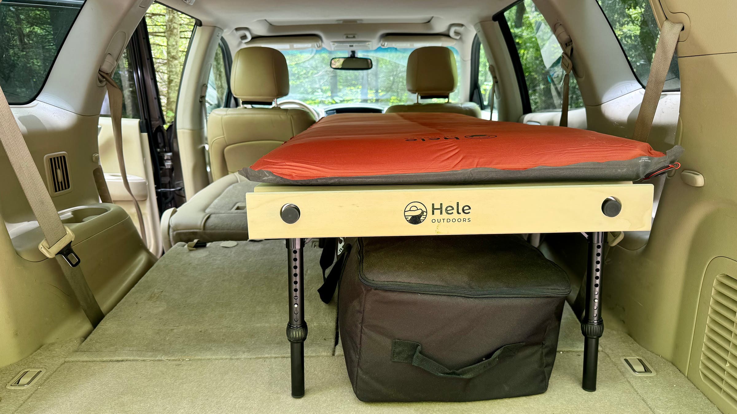 Closeup of Hele Box Car Camping Platform in the back of a beige SUV