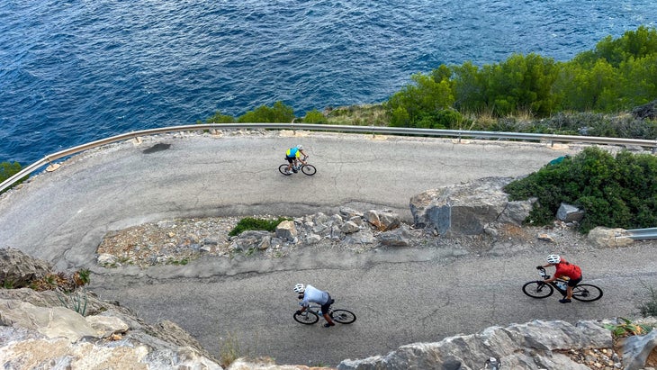 Cyclists windy road coast Mallorca
