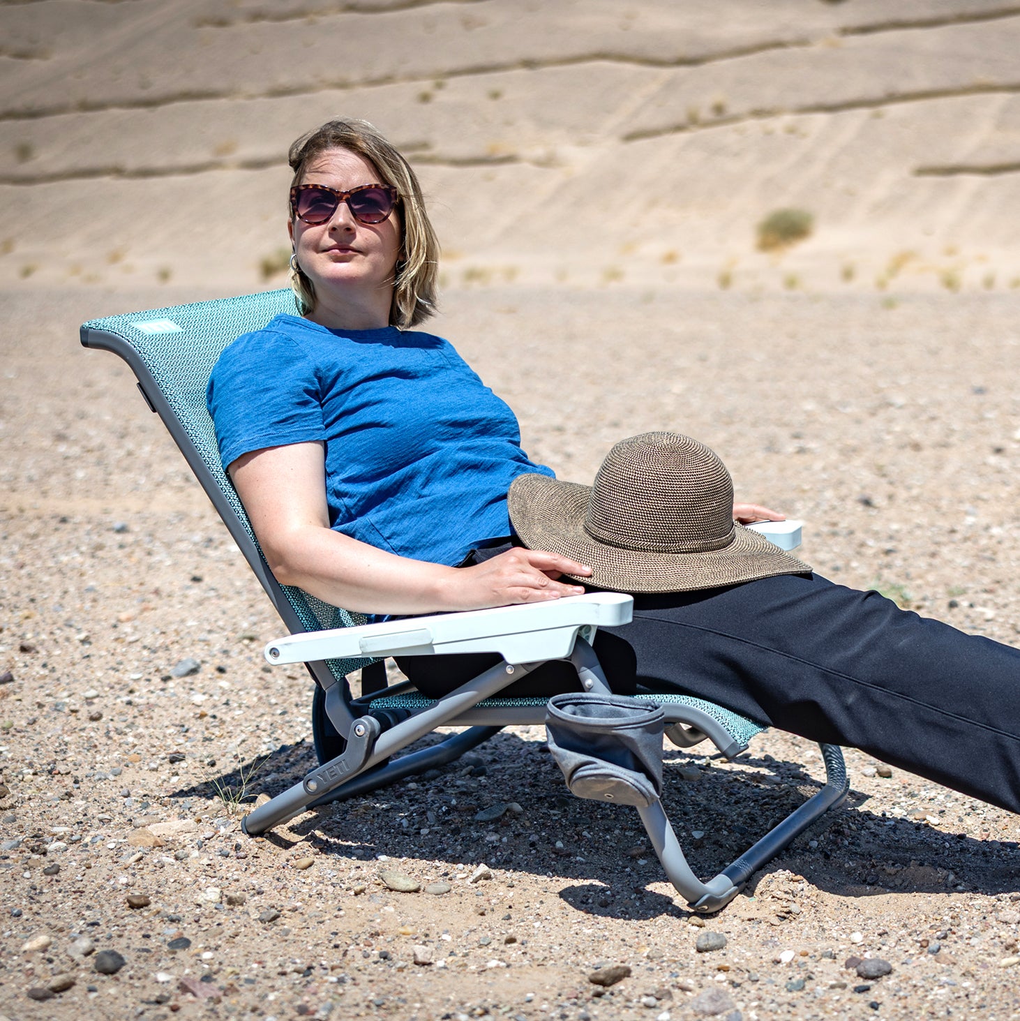 Woman sitting in Yeti Hondo Beach Chair in sand