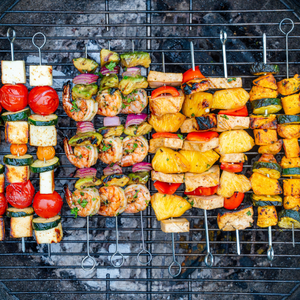 four types of skewer recipes on a grill