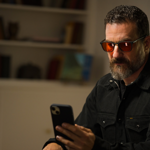 Andrew Huberman wearing red-tinted Wind Down glasses