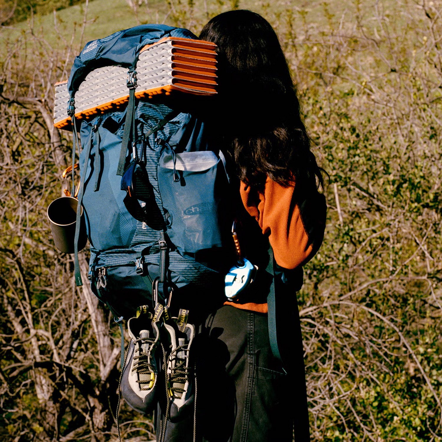 Woman hiker with backpacking pack filled with gear