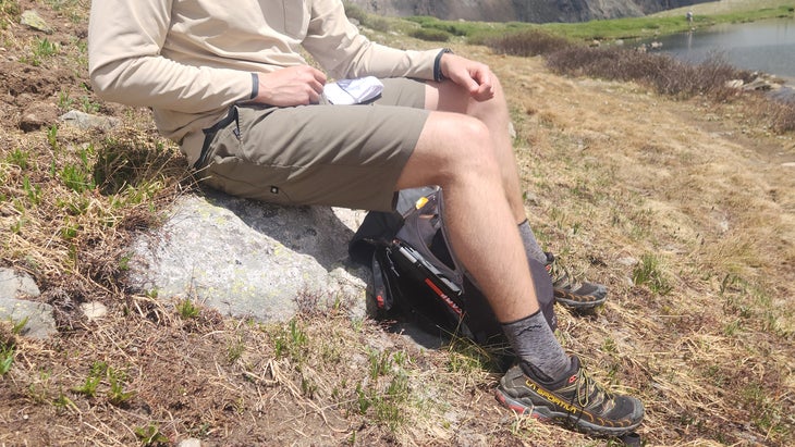 Closeup of hiker sitting on rock