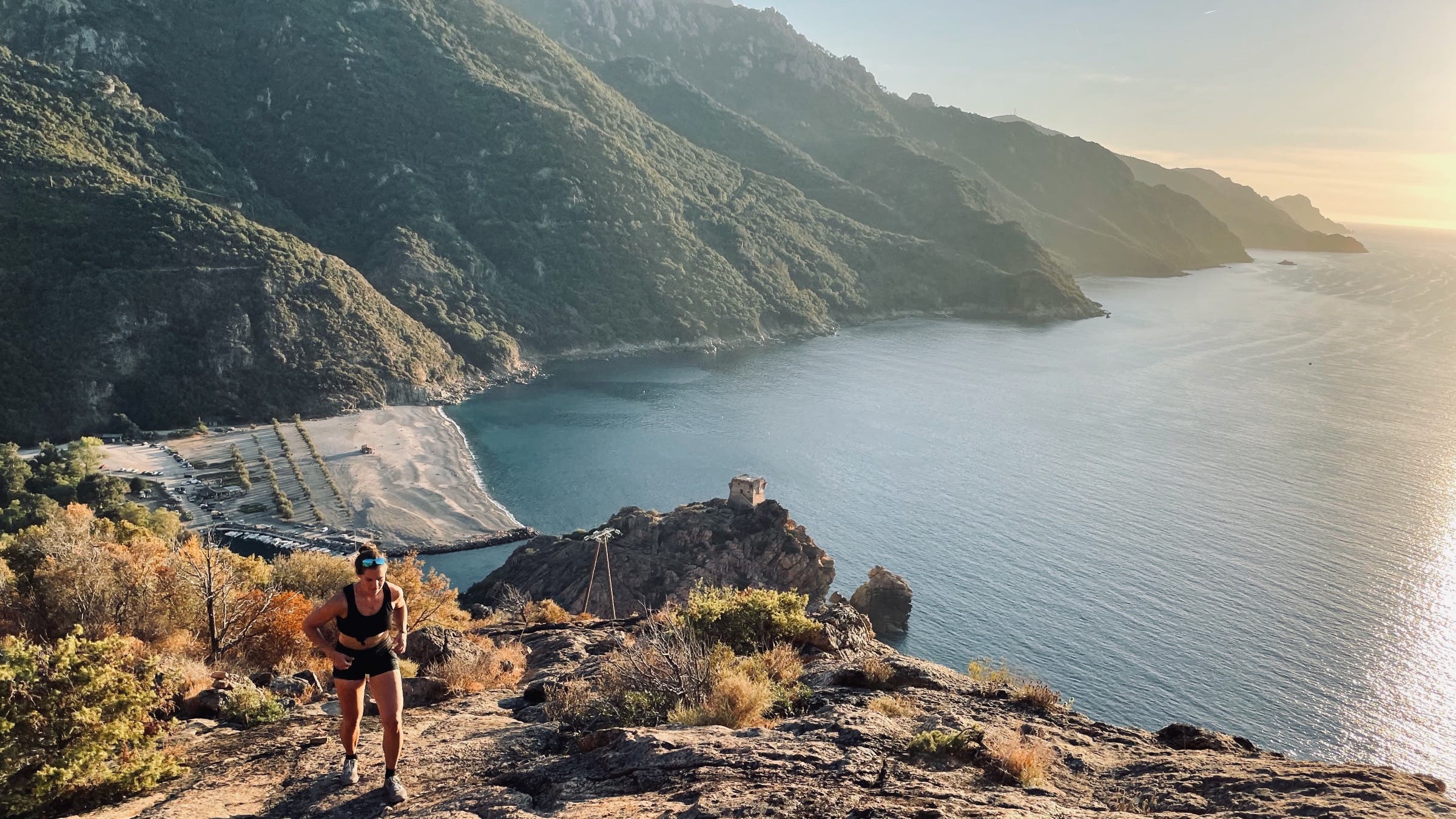 Woman hikes along coast Corsica